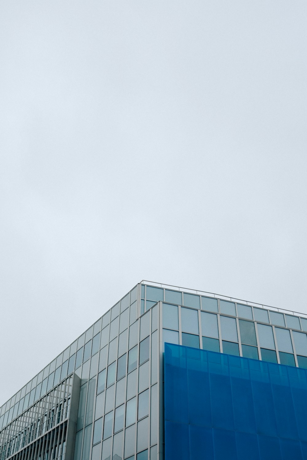 an airplane flying in the sky over a building