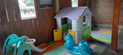 A vibrant playroom featuring interlocking floor mats with children playing.