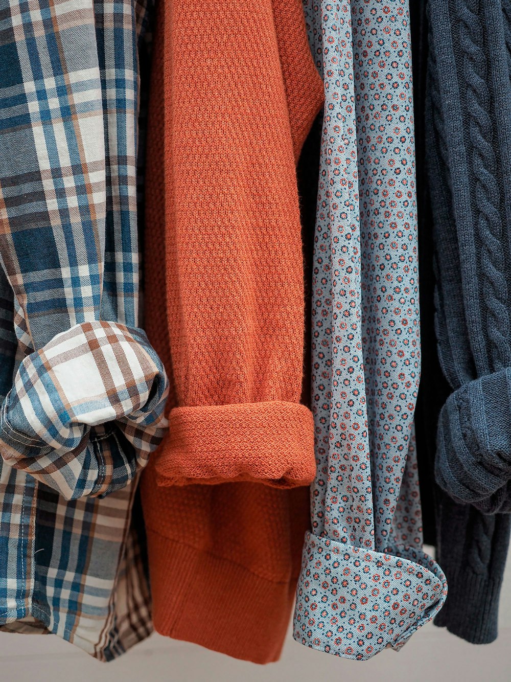 a bunch of different colored ties hanging on a rack