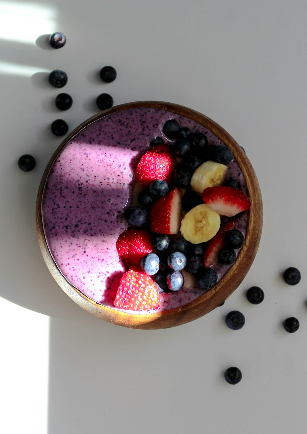 a bowl of fruit is sitting on a table