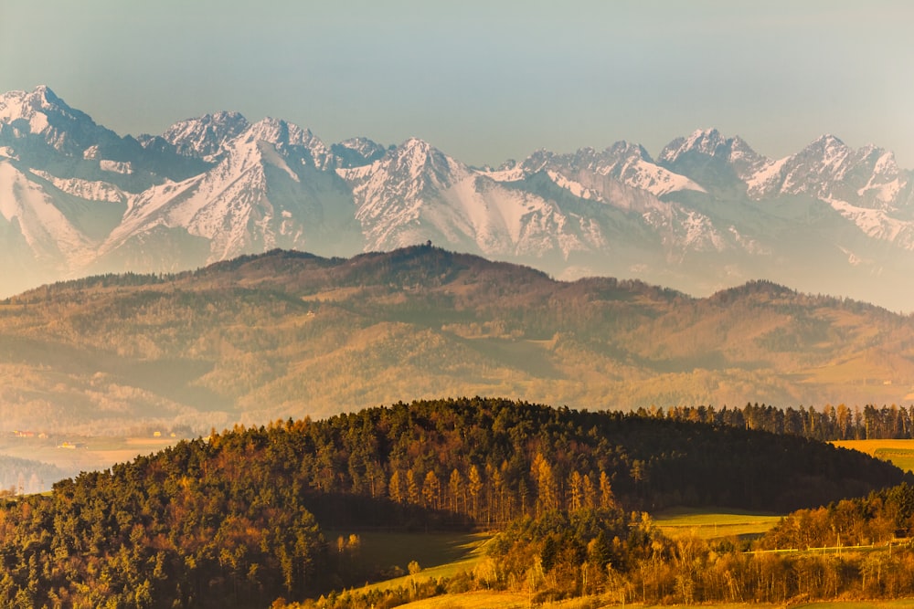 a mountain range with snow capped mountains in the background