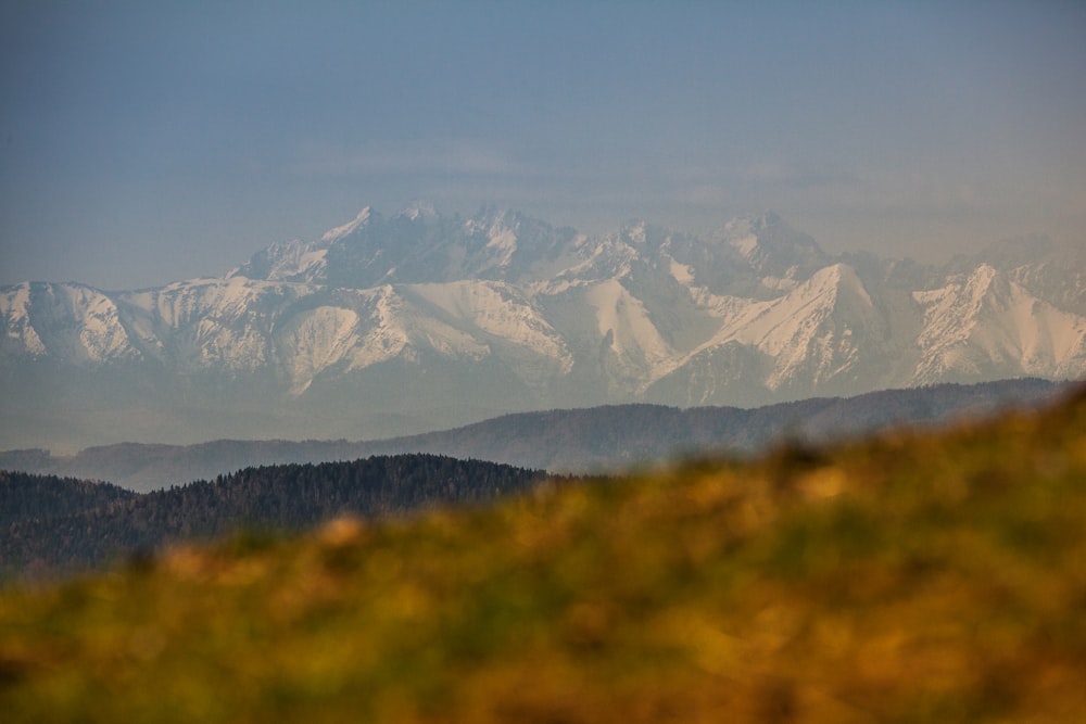 a mountain range with snow covered mountains in the background