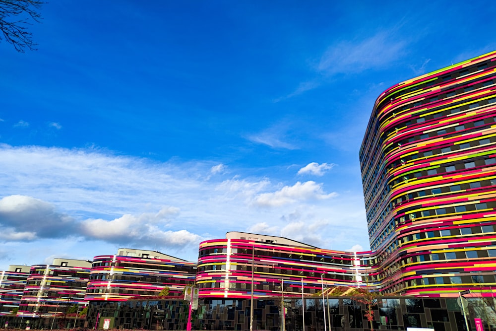 a multicolored building with a blue sky in the background