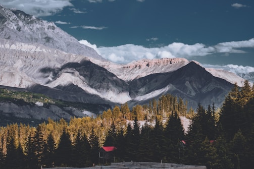 a mountain range with trees and mountains in the background