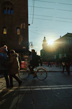 A city street scene showing a Veloza bike ride in progress during sunset.
