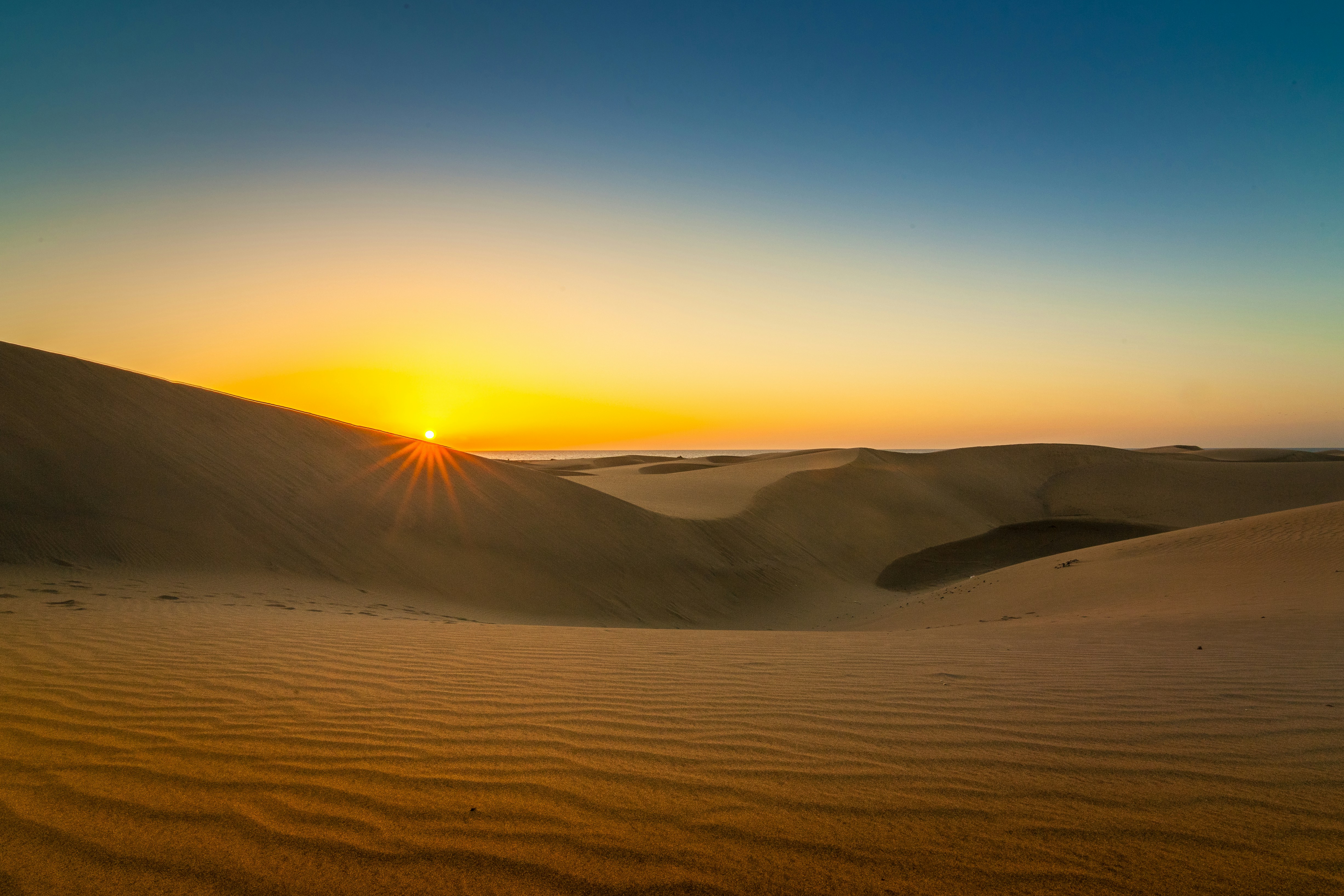 A magical sunset over sand dunes representing the dreamy world of Indian bedtime stories