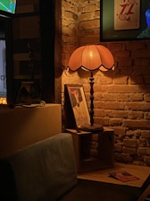 A cozy room softly lit by vintage brass sconces and nautical lamps from Ju Zu International.