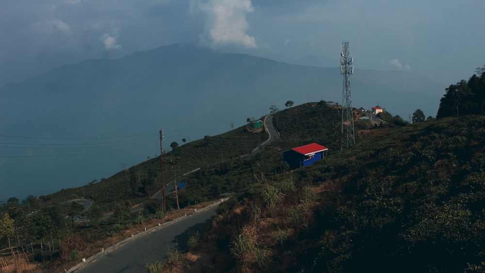 a house on a hill with a mountain in the background