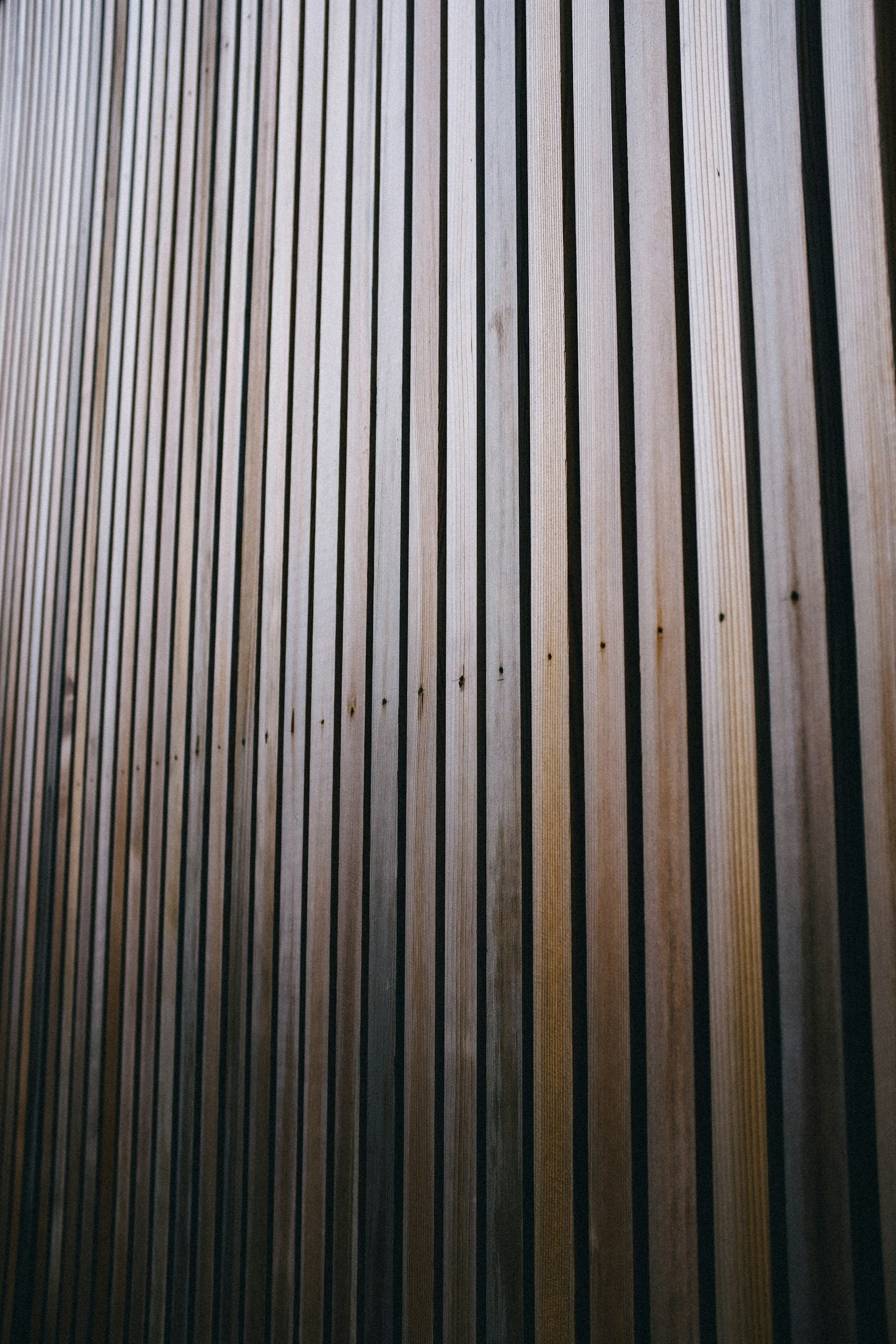 a close up of a wooden wall with a clock on it