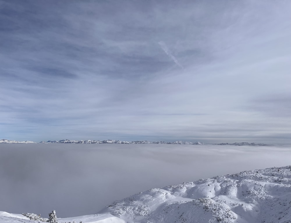 a person standing on top of a snow covered mountain