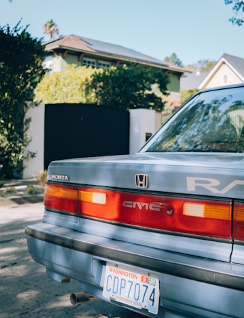 Rear view of a Brazilian car with license plate, driving through a residential area.