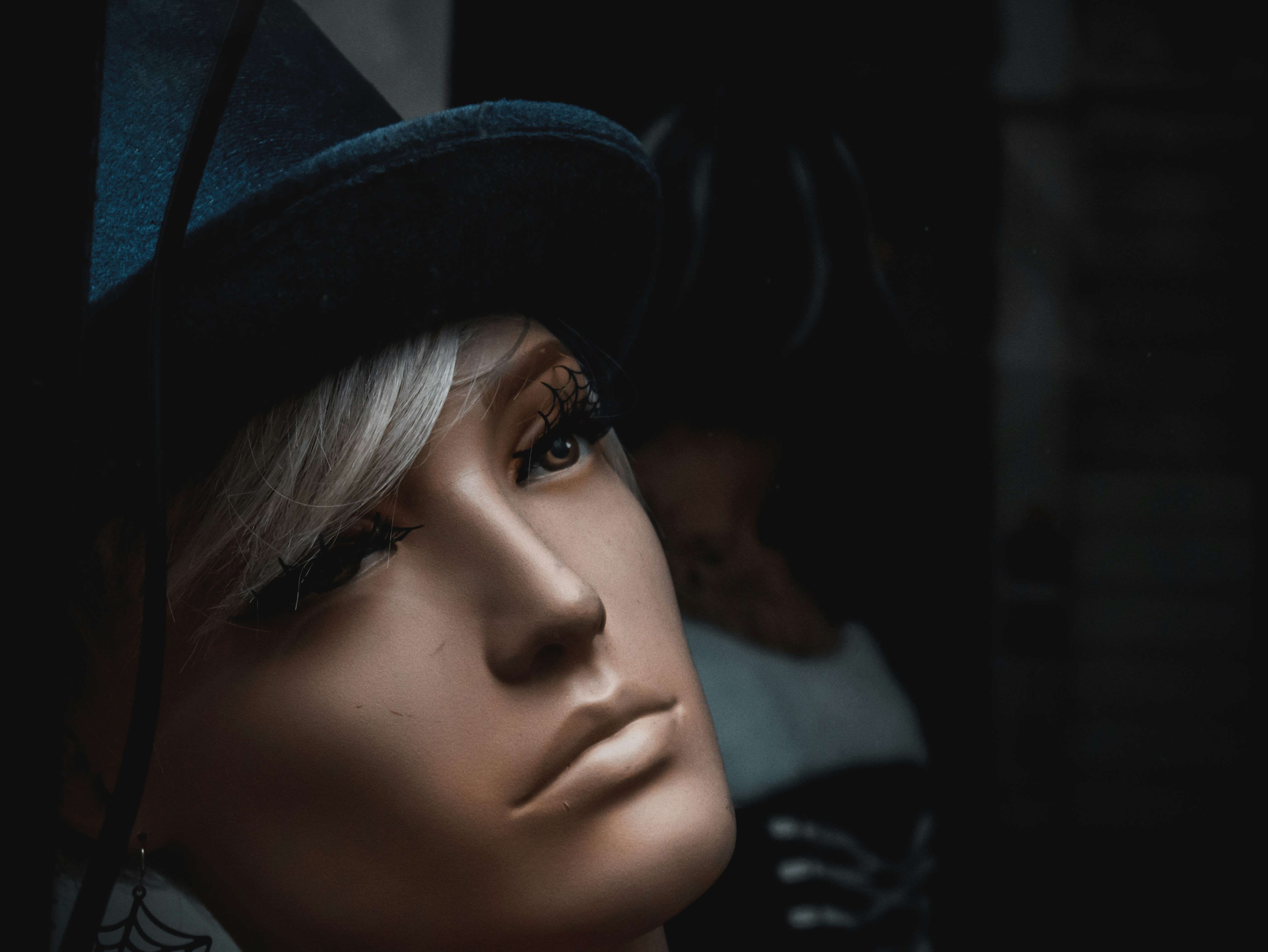 A dummy looks into the window with a sad and dreamy look