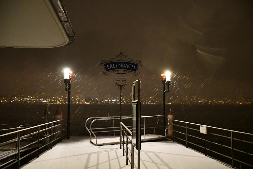 a pier with a light pole and a sign on it