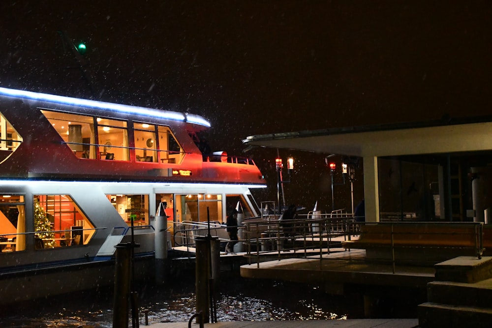 a boat is docked in the water at night