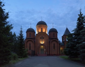 A serene view of God’s Divine Answers Ministry church building at Apo Resettlement, Abuja, under soft evening light.