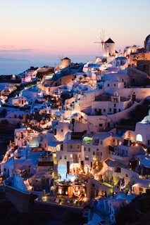 a view of a town with windmills lit up at night