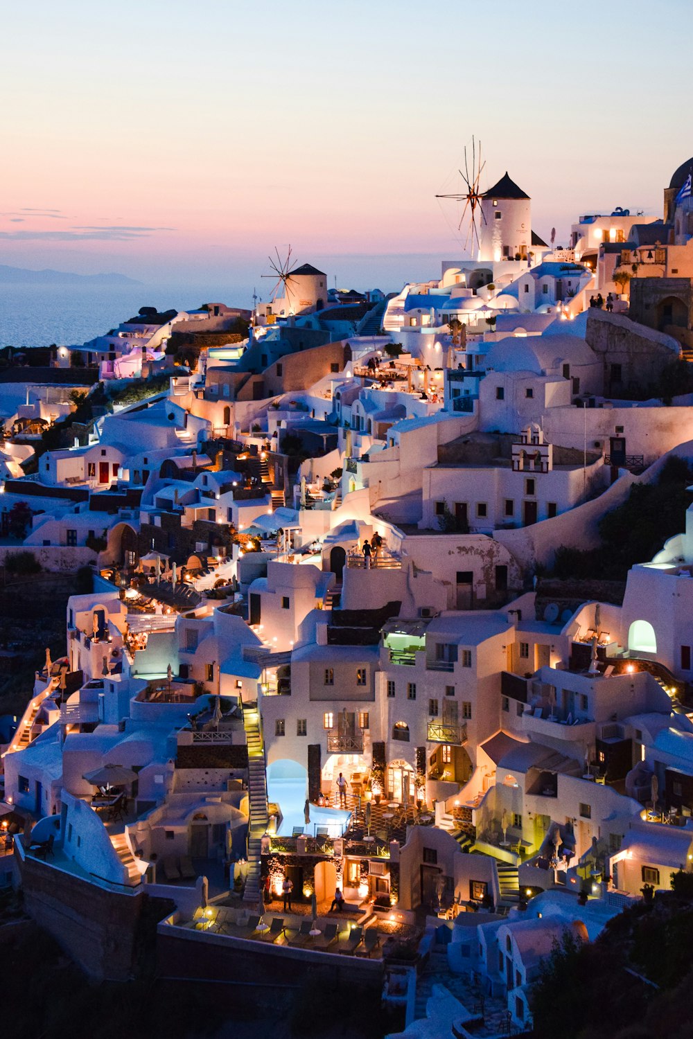 a view of a town with windmills lit up at night