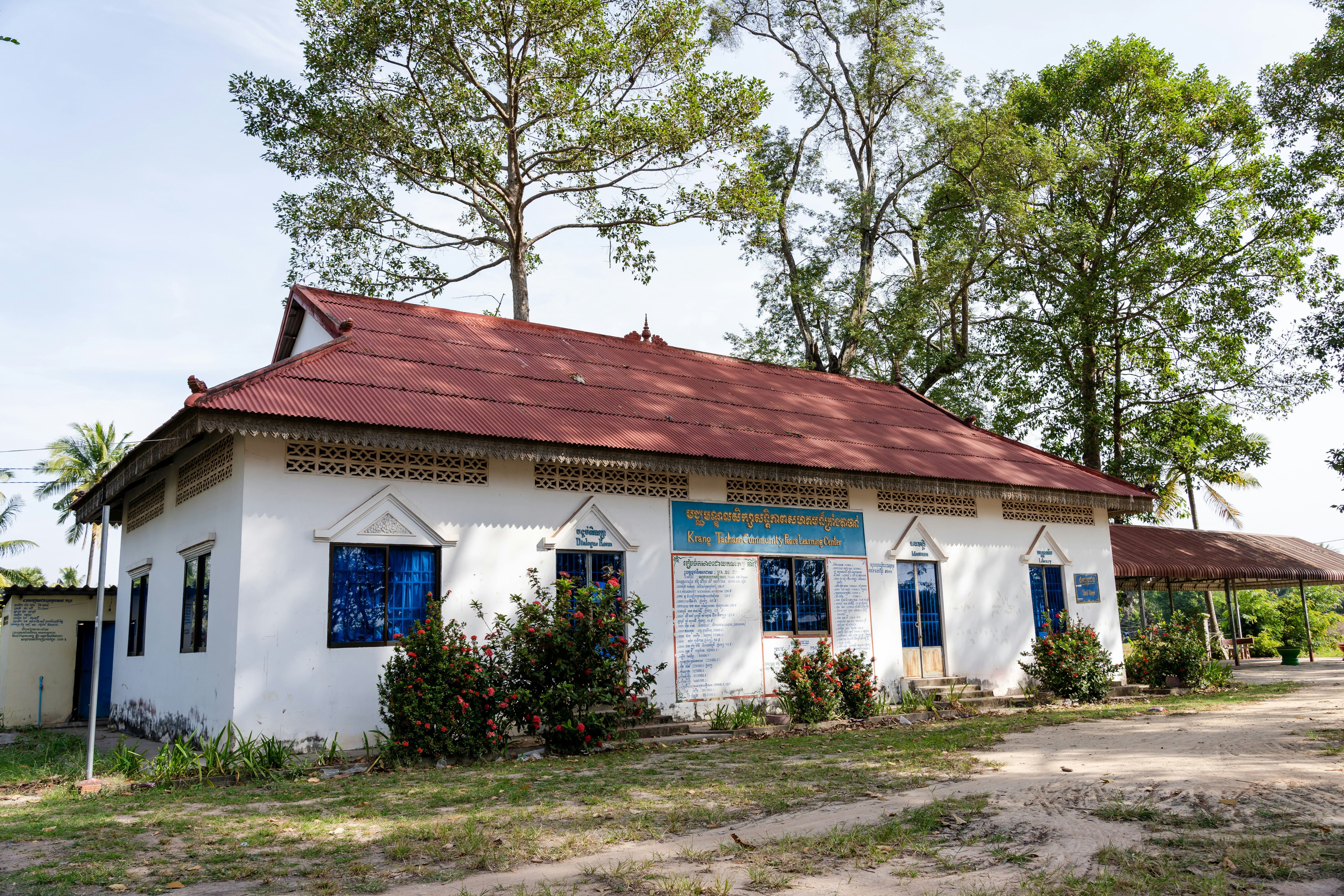 a small white building with a red roof