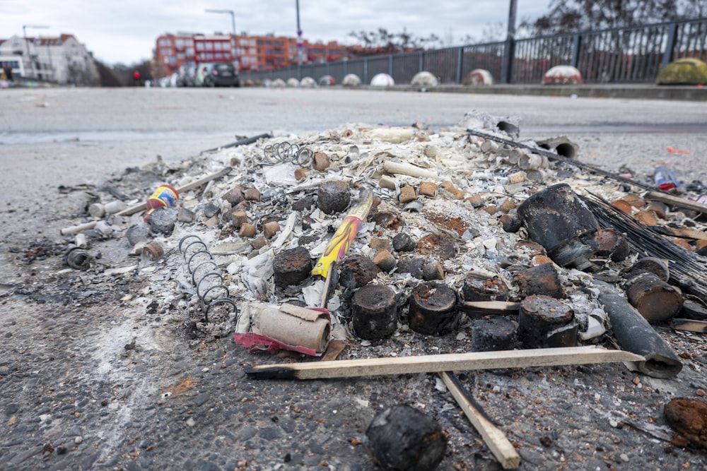 a pile of trash sitting on the side of a road