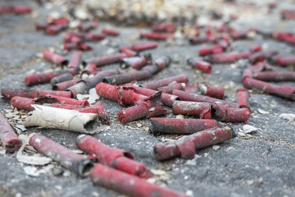a bunch of red crayons that are on the ground