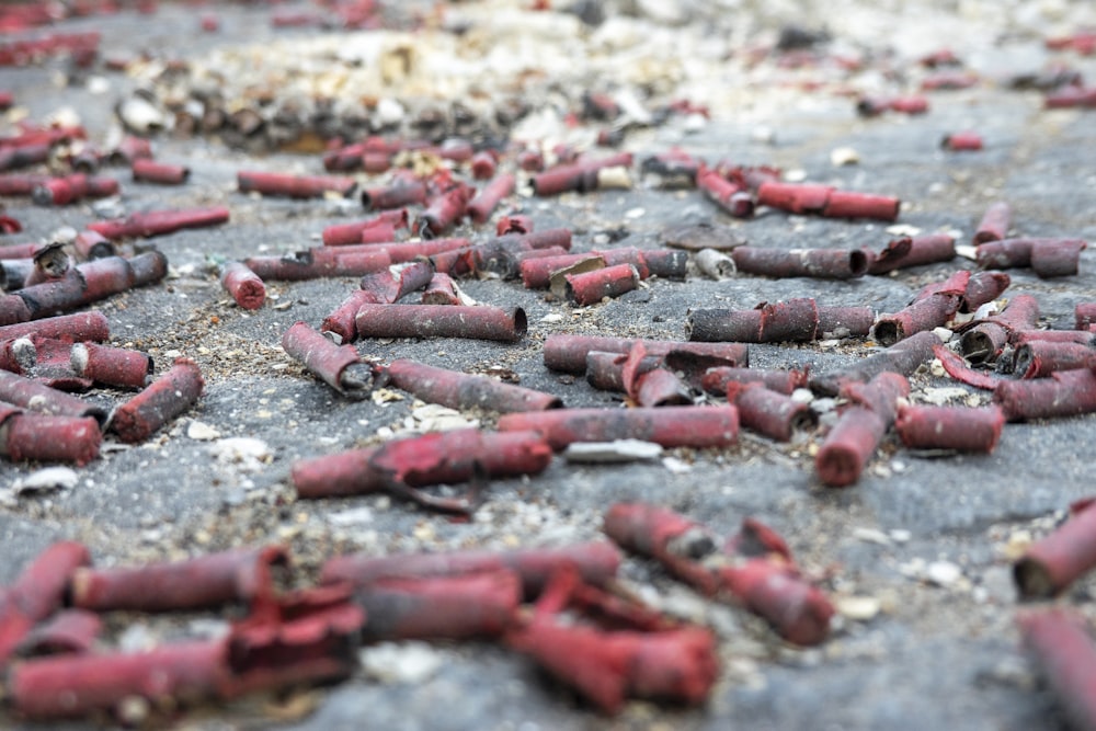 a bunch of red crayons laying on the ground