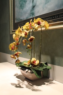 a vase with flowers in it sitting on a table