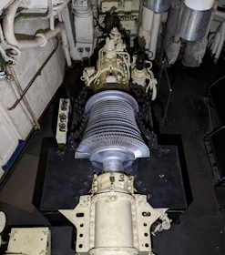 Engineers collaborating over technical blueprints in a wind turbine facility.