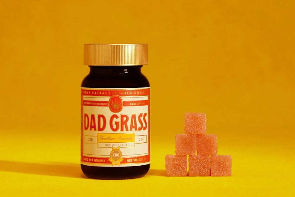 a bottle of dad grass next to a pile of sugar cubes