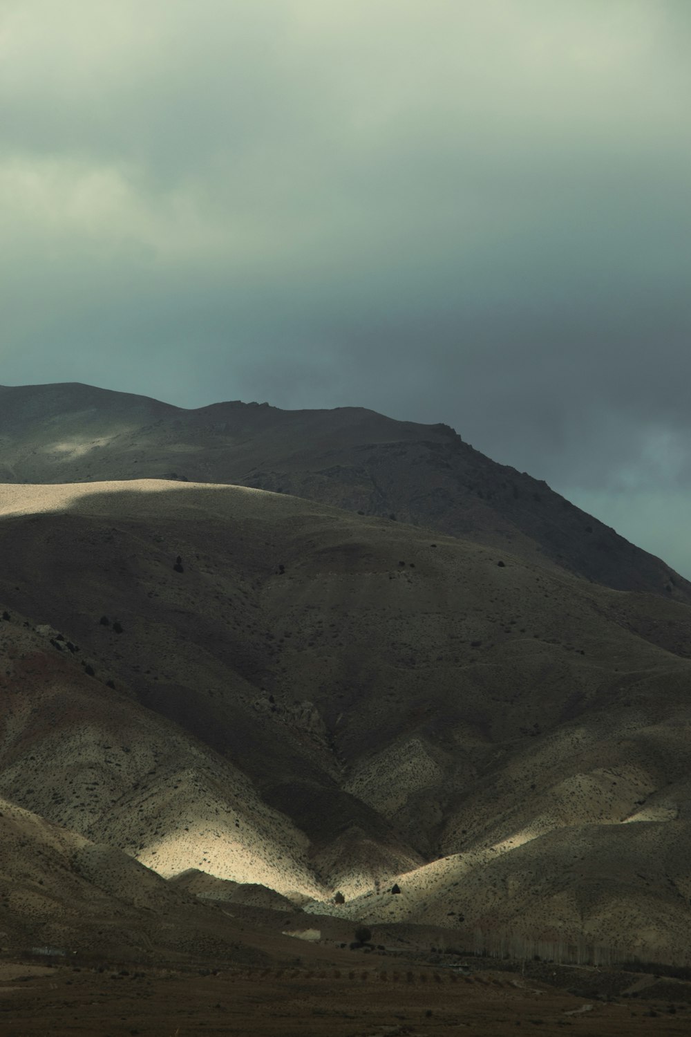 a hill with a few hills in the background