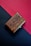 A beautifully crafted wooden gift box with intricate designs placed on a rustic table.