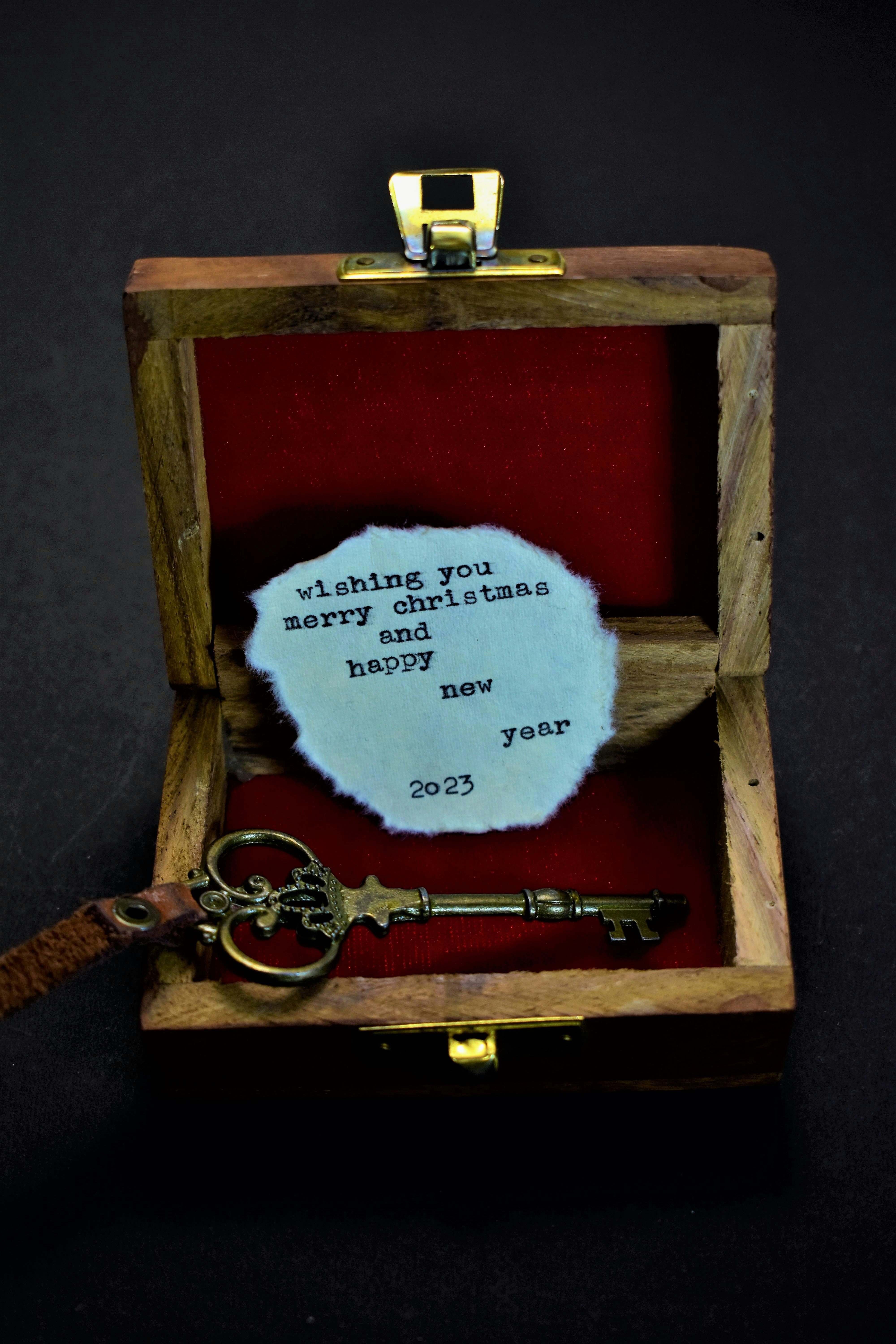 a wooden box with a key inside of it