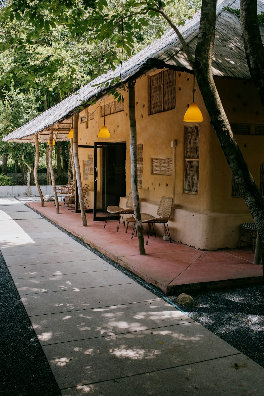 a yellow building with two lamps on the outside of it