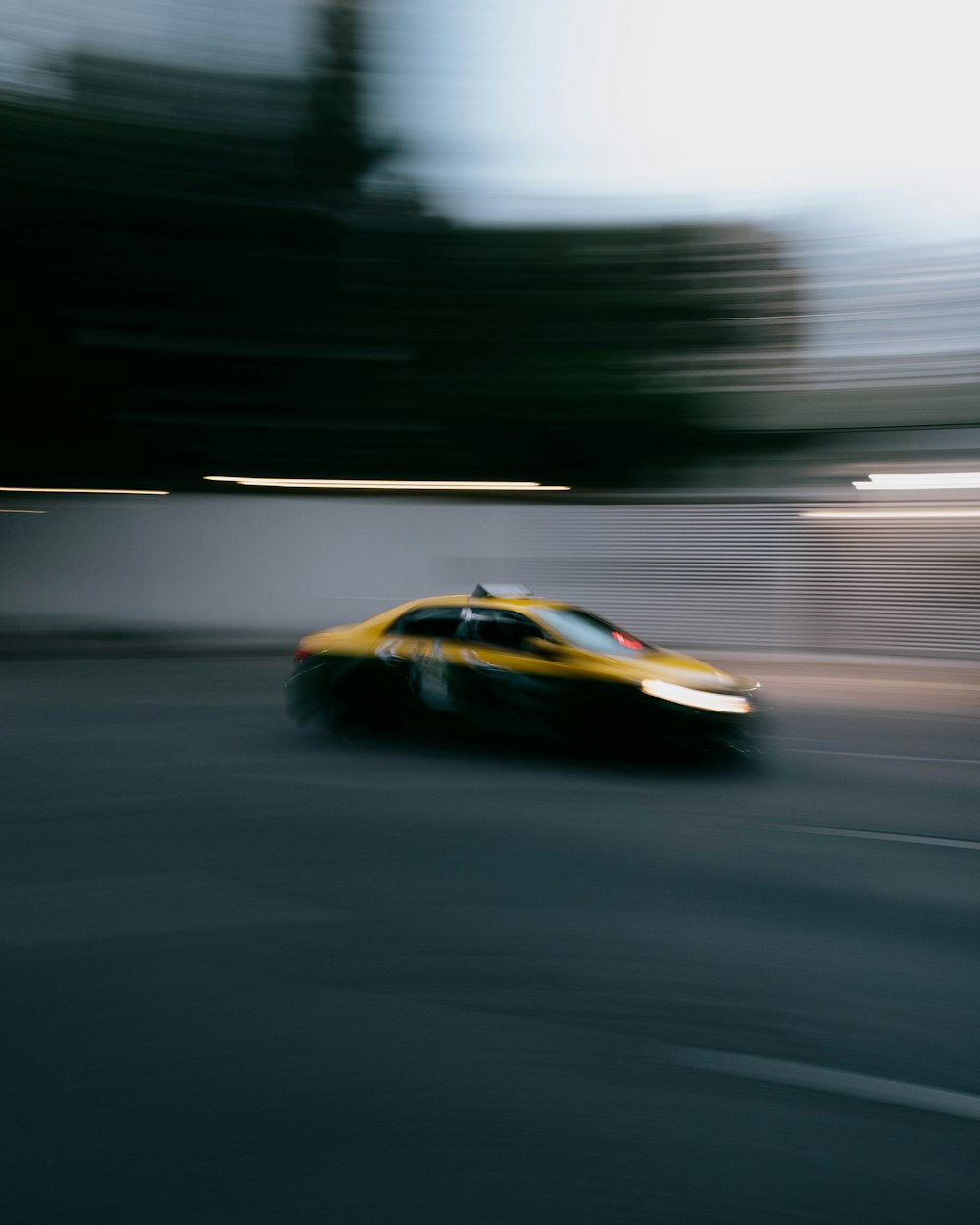 a blurry picture of a car driving down a street