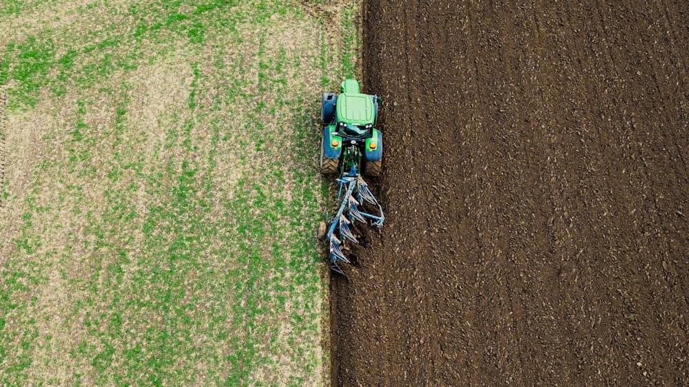 a tractor is plowing a field of grass