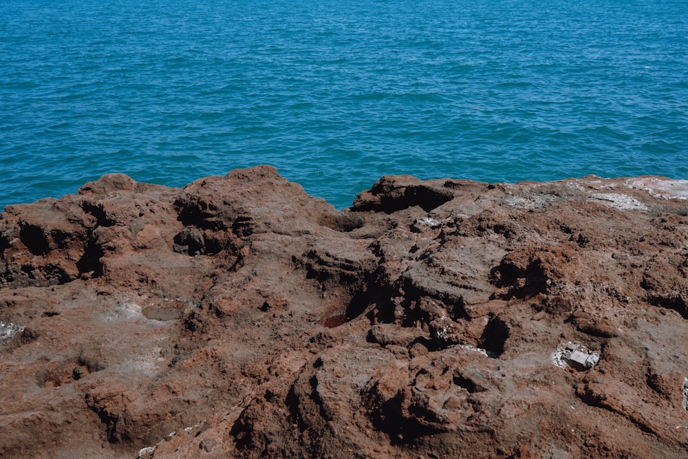 a rock outcropping in the middle of a body of water