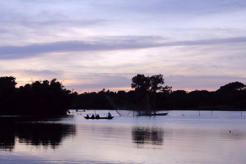 a couple of boats floating on top of a lake