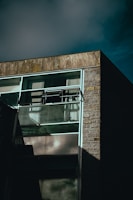 Modern real estate building facade featuring clean lines and stone textures under natural light