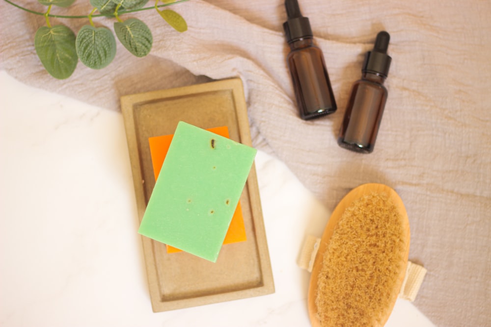 a wooden box with a sponge and a bottle of lotion next to it