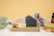 Close-up of a glowing amber soap bar resting on a sleek black dish with gold accents.