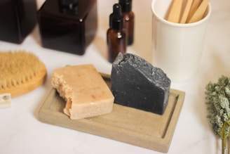 a couple of soaps sitting on top of a wooden tray