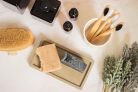 a table topped with a soap bar and a couple of wooden utensils