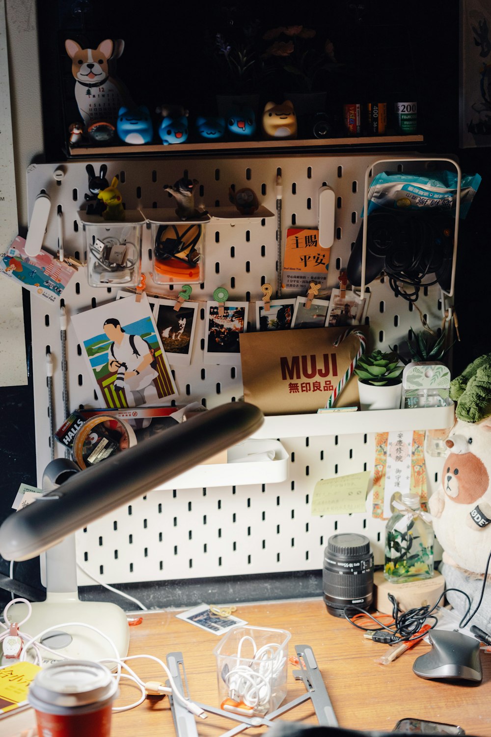 a cluttered desk with a computer mouse and a lamp