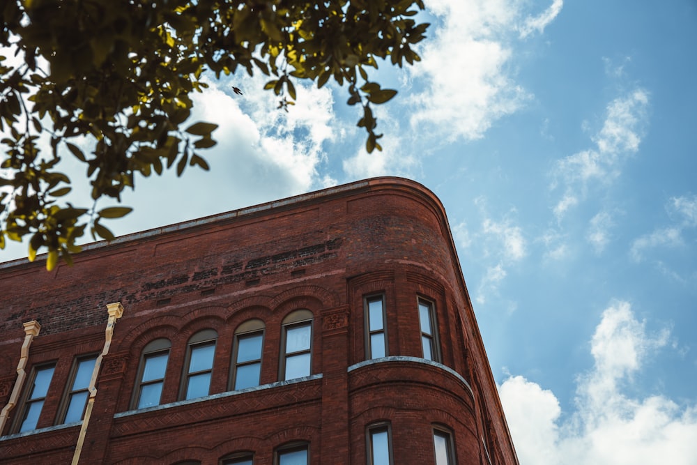 a tall brick building with a sky background