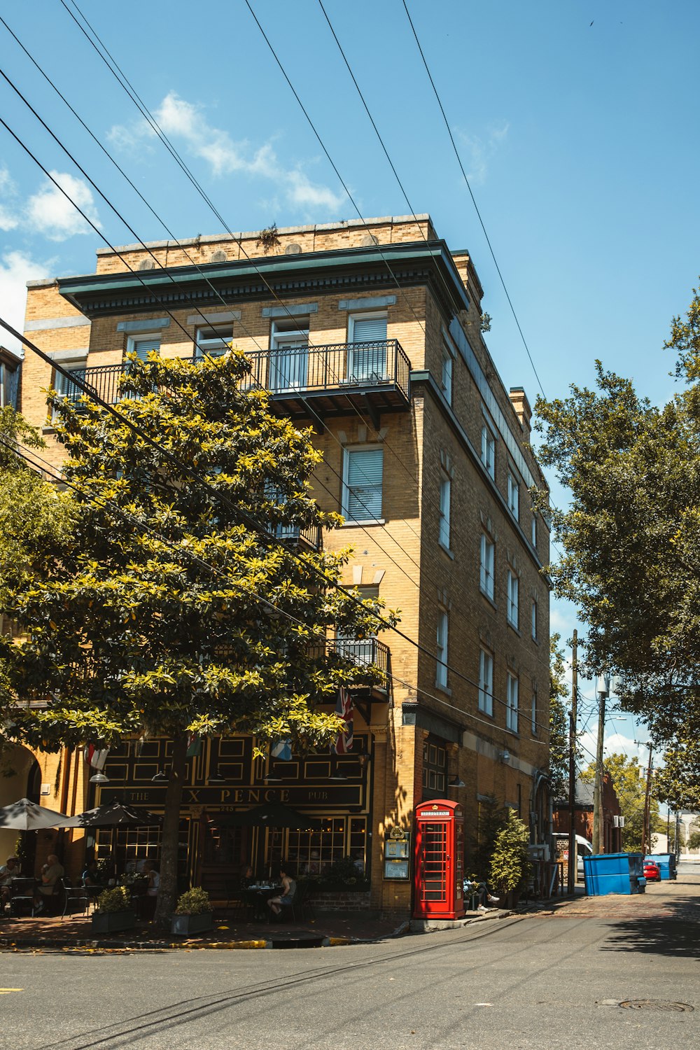 a tall brown building sitting on the side of a road