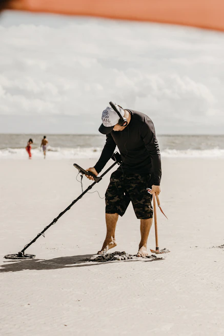 Professional treasure hunter scanning rocky terrain with advanced underground imaging equipment