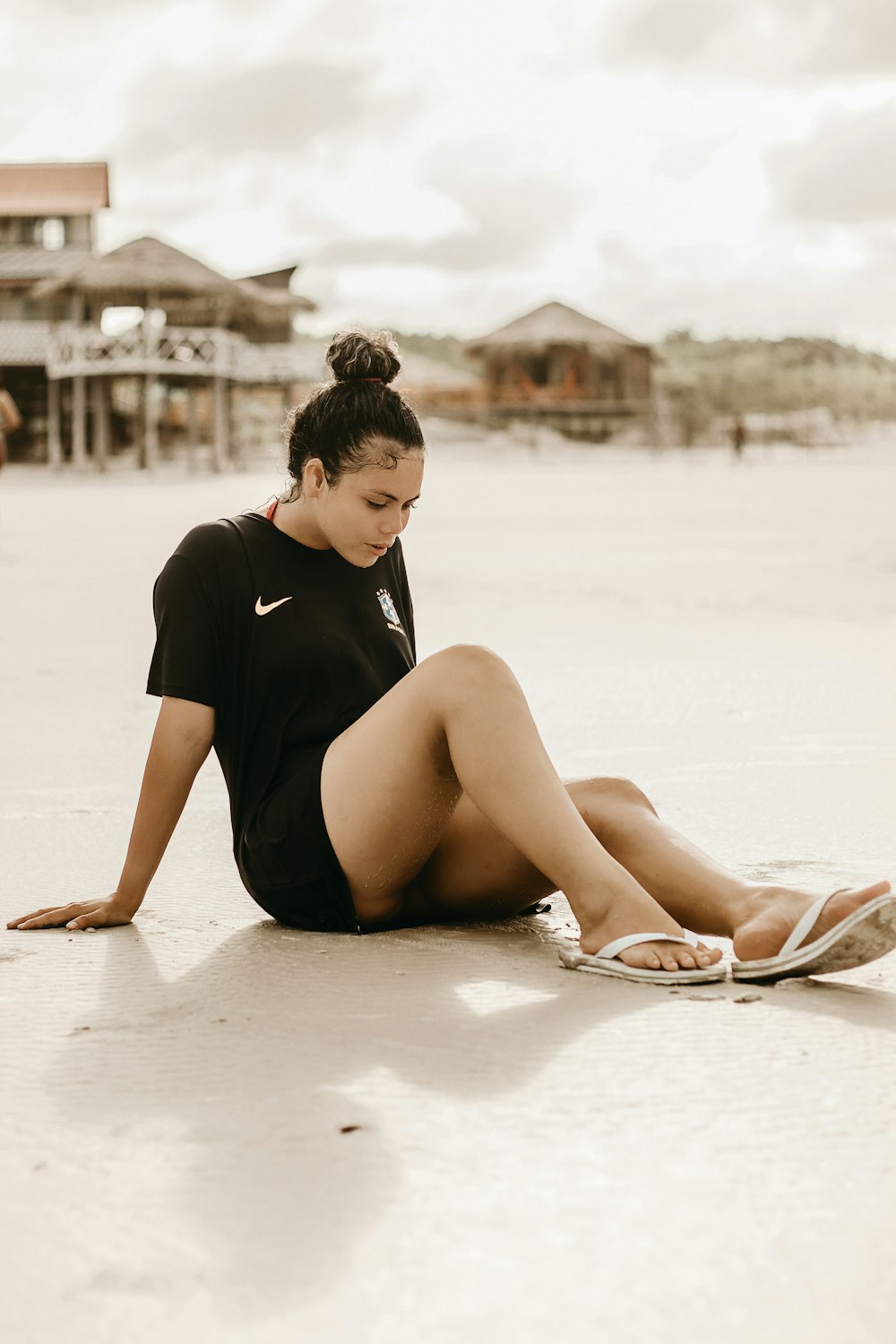 a woman sitting on the ground with her legs crossed