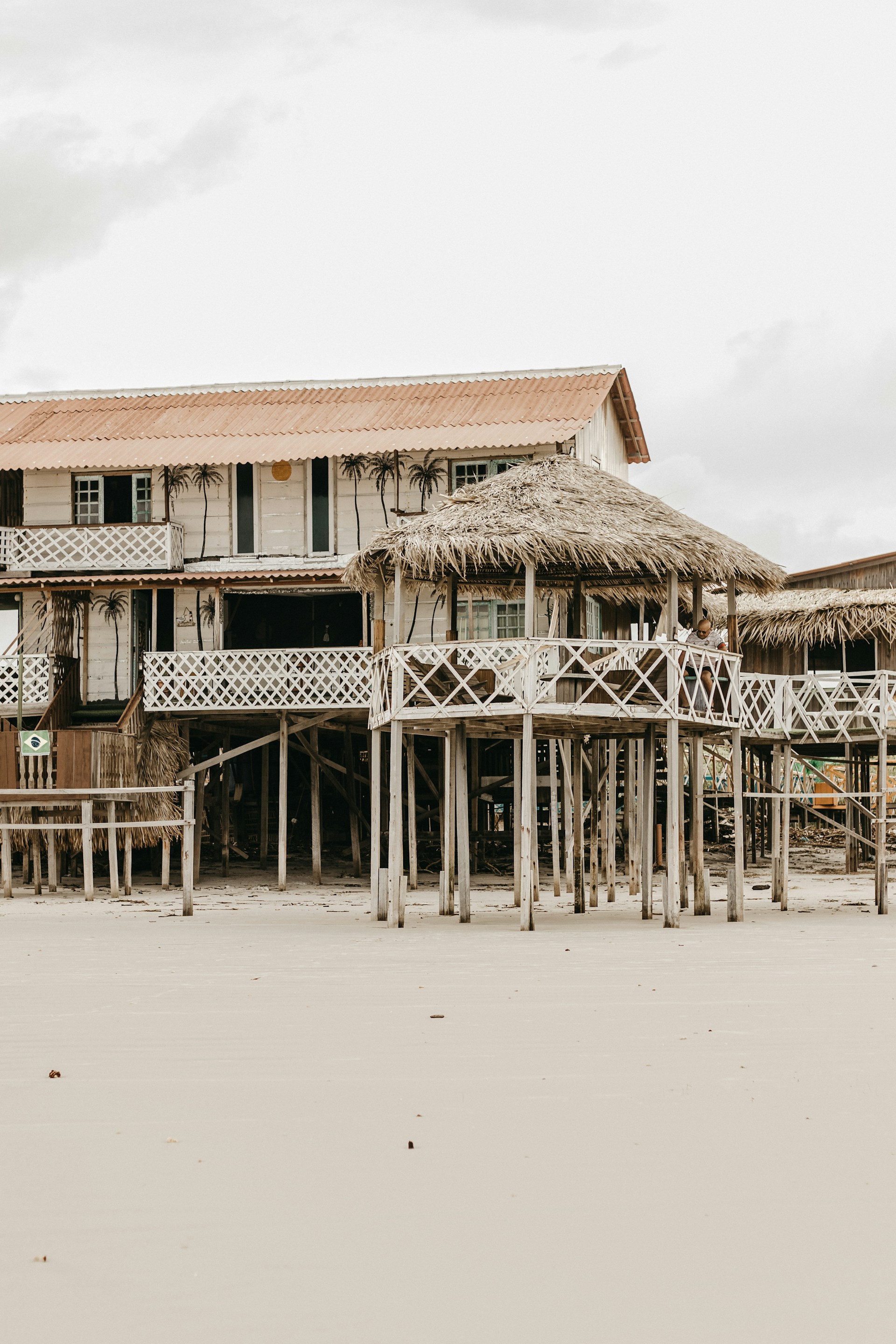 A beautiful beach ranch home near the coast of El Salvador, showcasing wooden beams and large windows.
