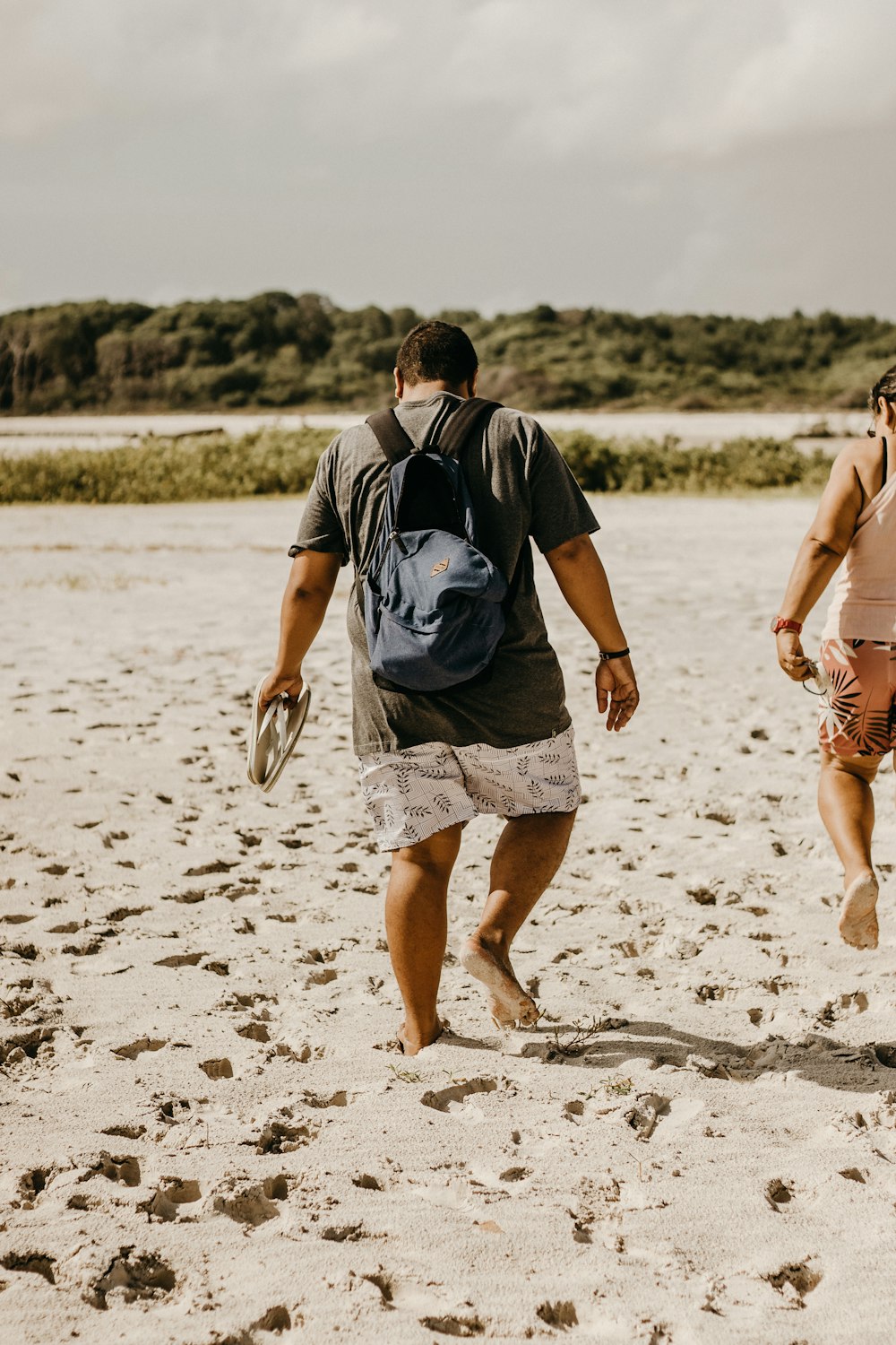 a man and a woman walking on a beach