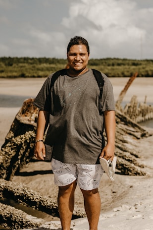 Happy customer wearing stylish sandals while walking on a sunny beach boardwalk.