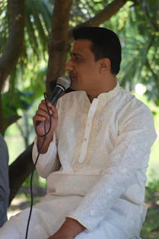 A concerned constituent speaking with Rajeev Tirkey during a community meeting